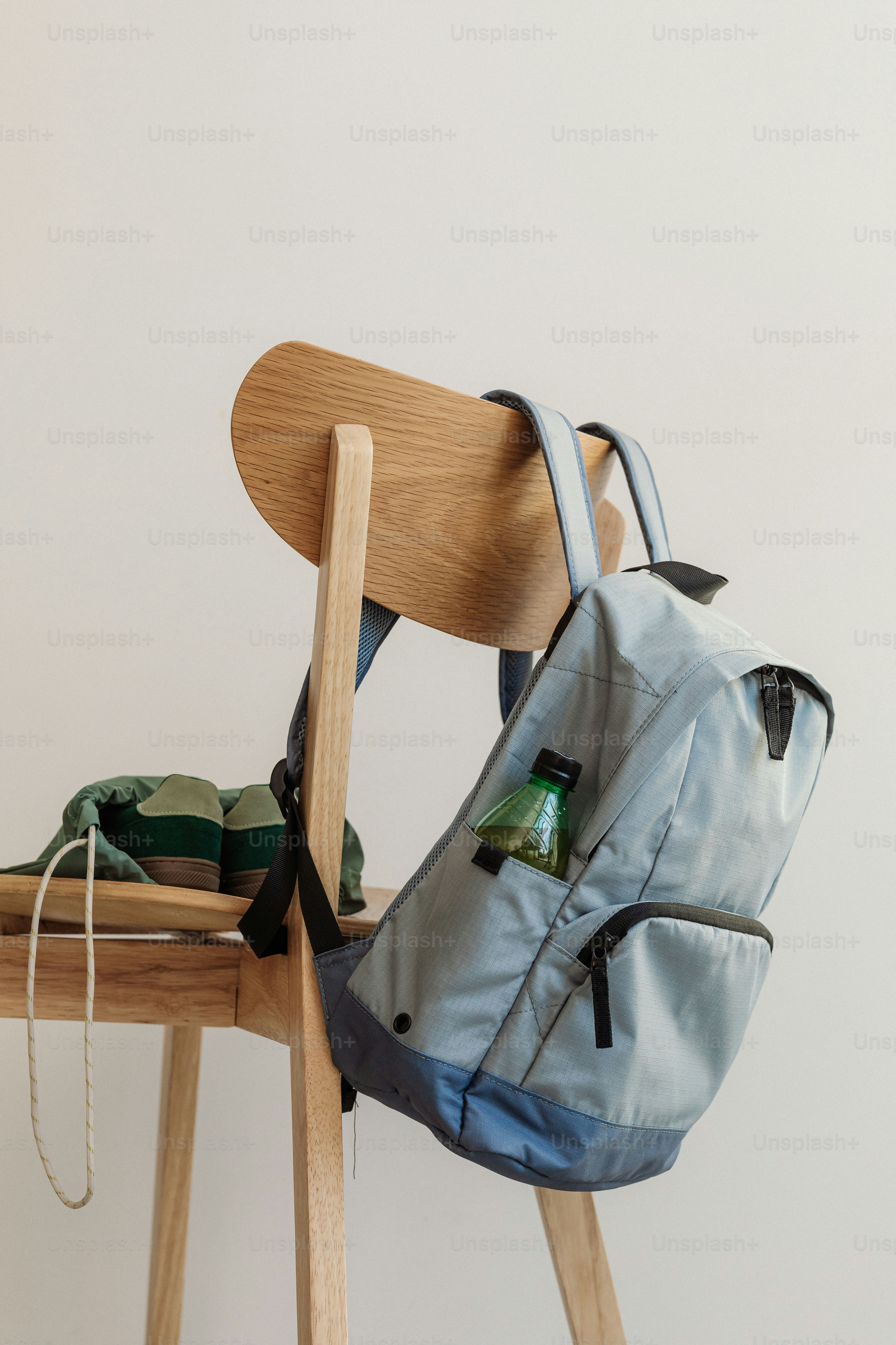 A backpack sitting on top of a wooden chair